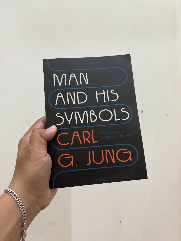 Man and His Symbols by Carl G. Jung held in hand